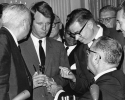 Washington:  President Johnson hands several pens to Attorney General Robert Kennedy during a ceremony at the White House for the signing of the Civil Rights Bill into Law."Roy Reuther between Kennedy and LBJ."July 2, 1964