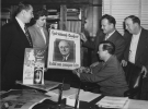 1949 "Wayne County Chapter of the National Foundation for Infantile Paralysis.  Walter Reuther looking at March of Dimes poster, (hand in brace, seated at desk) "left to right: Emil Mazey, unidentified lady, WPR, Jack Livingston, Richard Gosser.