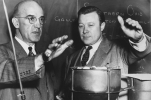 In 1947, Reuther attempted to get Michigan municipalities interested in a new process for distilling oil from coal and eliminating the power wasted in soot and smoke.  Walter Reuther (right) tests the heat from the smokeless fuel residue of the oil distilling process.  Left is Mr. Lewis C. Karrick, former U.S. government research geologist, who invented and patented the oil from coal process.