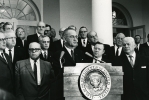 President Lyndon B. Johnson addressing an audience with Walter Reuther at his side.