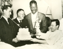 Members of UAW Local 30 presenting a cake to Walter Reuther while he was recovering from gunshot wounds, 1948.