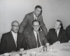 Civil rights meeting(?) 

Standing is Whitney Young.  Seated:  unidentified, Senator Phil Hart, and Walter Reuther.